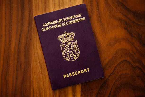 istock New Luxembourg passport on a brown-wood table, copy space 2185781036
