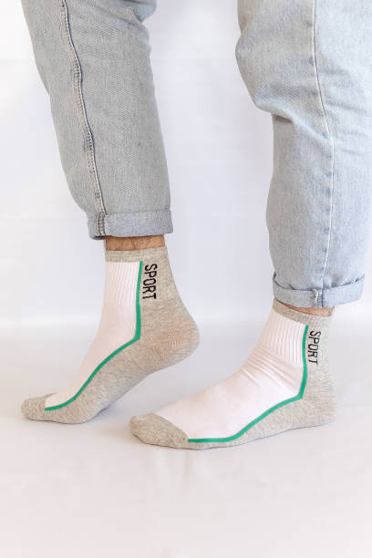 istock two Men's Leg in Jeans and white grey Socks on White Background 2185781102