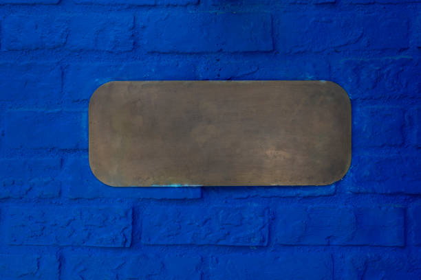 istock Blank metal logo on blue brick wall 2185782148