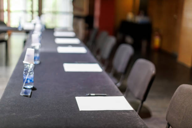 istock Empty conference table with papers and pens ready for a meeting 2185783485