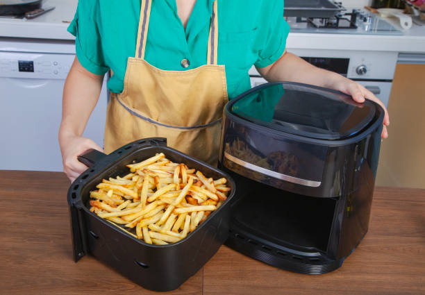 istock Woman using air fryer in the kitchen. 2185785031