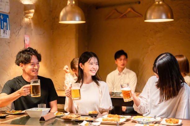 istock Young men and women drinking alcohol at a tavern 2185785847