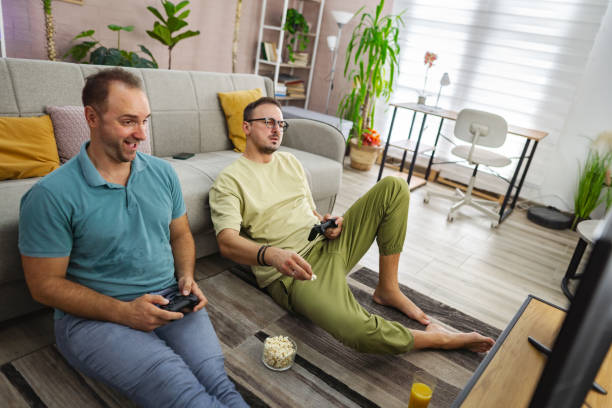 istock Two men playing video games at home and having fun 2185785894