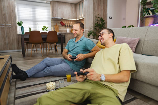 istock Two men having fun playing video games at home 2185785934
