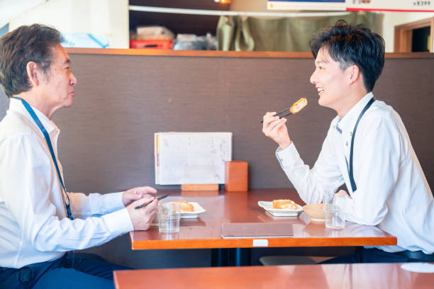 Two businessmen eating lunch at a restaurant