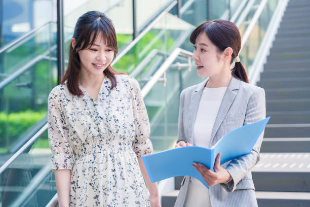 istock Female businessperson walking through the office while talking happily 2185786761