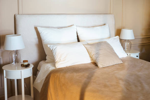 istock Cozy bedroom setting with plush pillows and soft bedding during daylight hours 2185786866