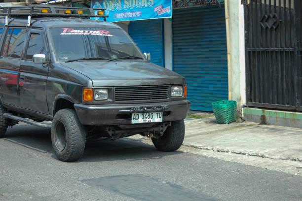 Indonesia, Sukoharjo - November 21, 2024 : old black car crosses the highway