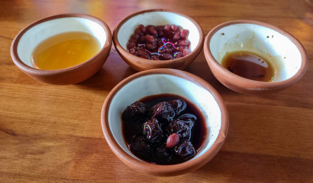 Various jars of fruit jam on wooden background
