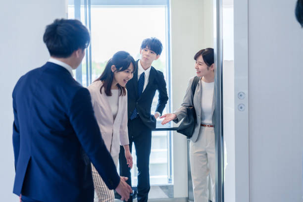 istock Business person riding an elevator in an office 2185788390