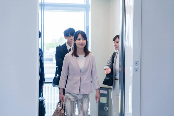 istock Business person riding an elevator in an office 2185788395