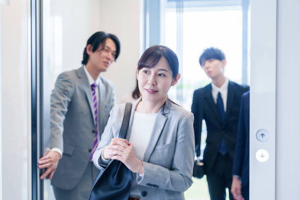 istock Business person riding an elevator in an office 2185788414
