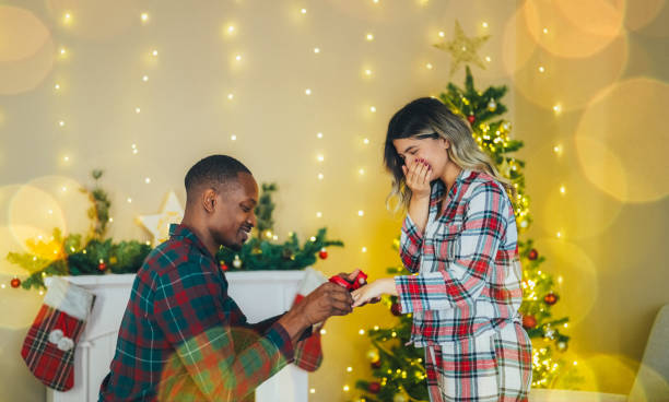 istock Young man proposing to his girlfriend on Christmas Eve 2185788568