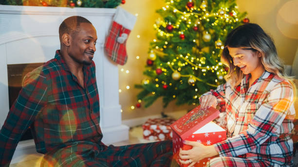 istock Young couple celebrating Christmas at home 2185788957