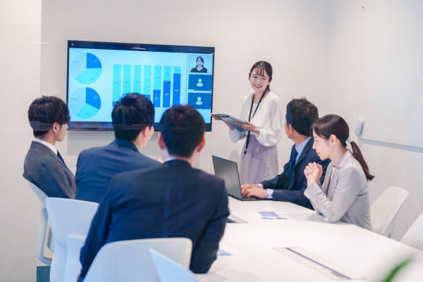 istock Young woman giving a presentation in a conference room 2185790213