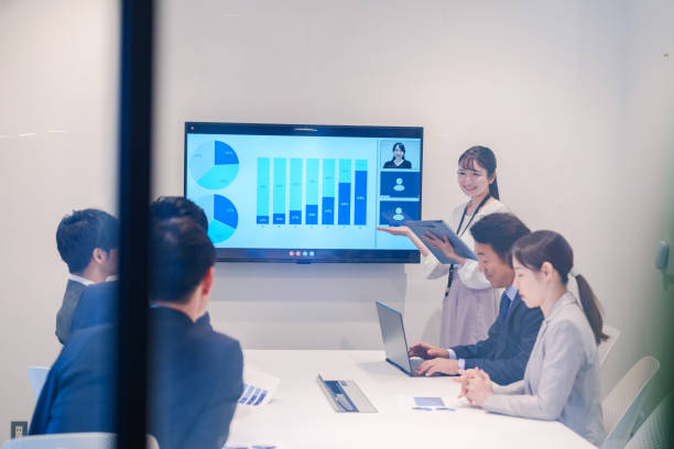 istock Young woman giving a presentation in a conference room 2185790219