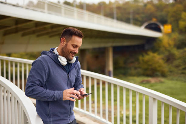 istock Smiling Man Enjoying Outdoor Walk with Smartphone 2185790822