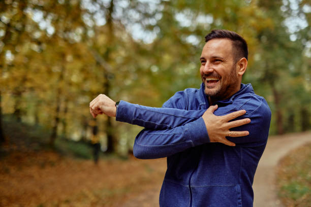 istock Smiling Man Stretching in Autumn Park Setting 2185791213