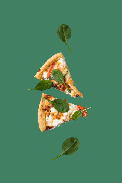 Floating pizza slice with fresh greens