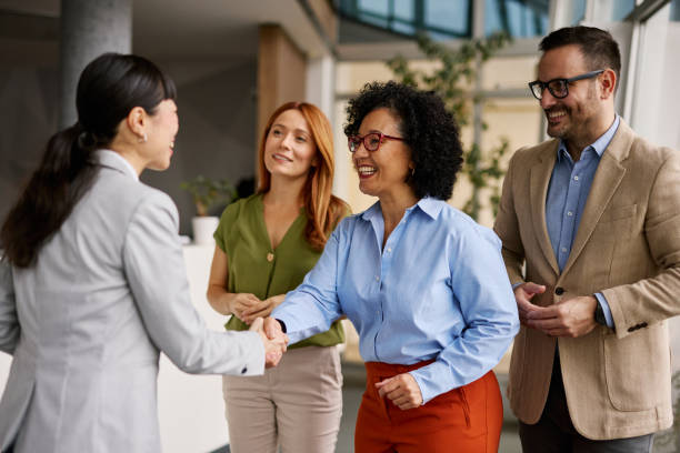 istock Diverse Business Colleagues Shaking Hands in a Modern Office 2185791628