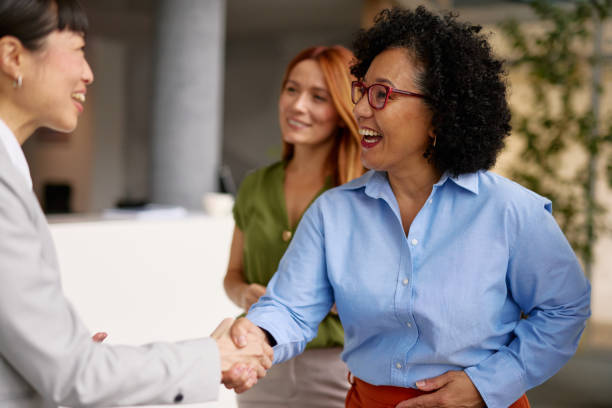 istock Diverse Business Colleagues Shaking Hands in a Modern Office 2185791632