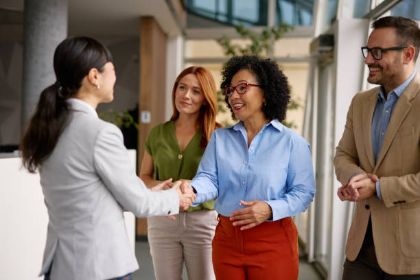 istock Diverse Business Colleagues Shaking Hands in a Modern Office 2185791663