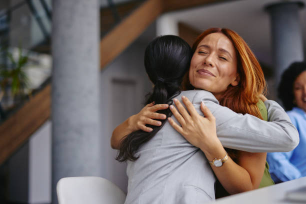 istock Warm Embrace Among Colleagues in a Modern Office Environment 2185791819