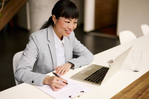 istock Professional Woman Working on Laptop in Modern Office Setting 2185791939
