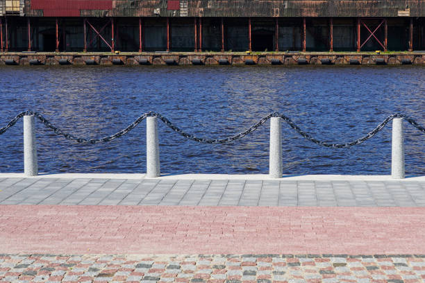 istock Concrete posts connected by a metal chain demarcate the waterfront, modern infrastructure example 2185795556