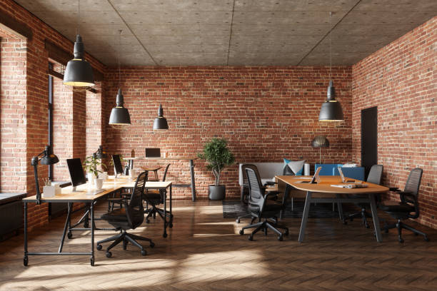 istock Industrial Style Open Plan Office With Brick Wall, Pendant Lights, Conference Table, Office Chairs And Computers 2185796354