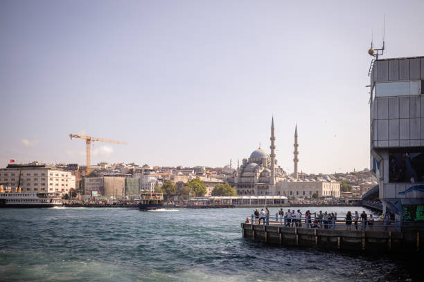 istock Bustling city with cranes and a majestic mosque skyline 2185798319