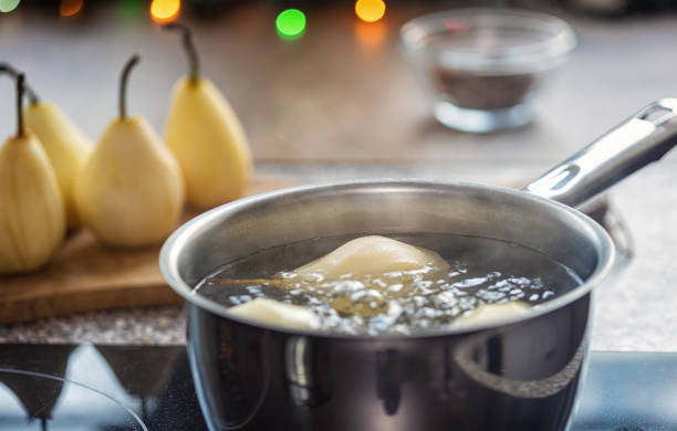 Baked pears with honey, walnuts and cranberries on white wooden table