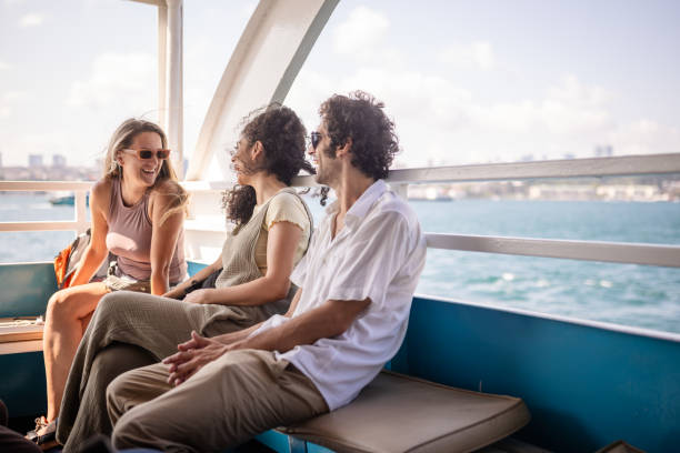 istock Friends laughing on boat during sunny day excursion 2185800311