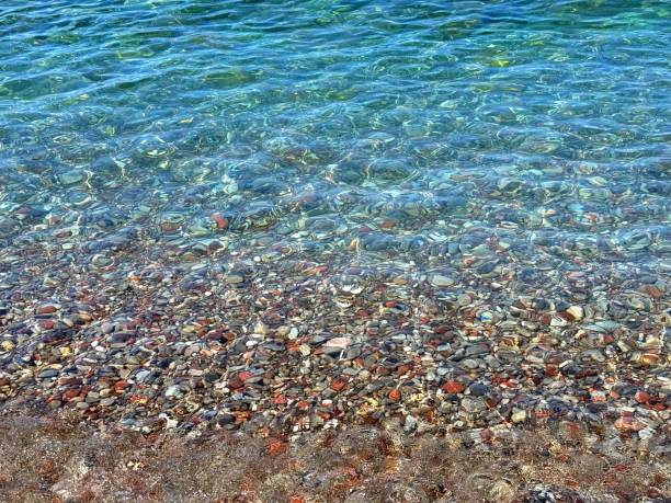 istock Blue clear sea with colorful pebbles at the bottom 2185800610