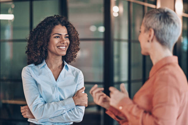 istock Two beautiful businesswomen talking 2185801265