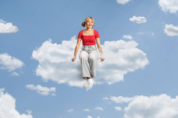 istock Young filipina woman sitting on a cloud 2185806451