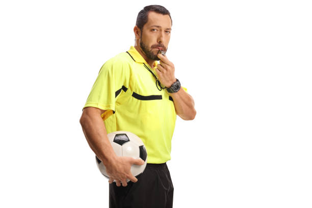istock Football referee blowing a whistle and holding a ball 2185807013