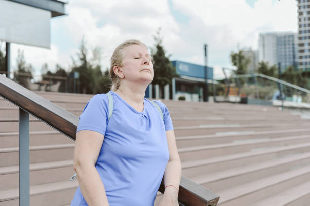 istock Peaceful Elderly Woman Outdoors with Closed Eyes 2185807542