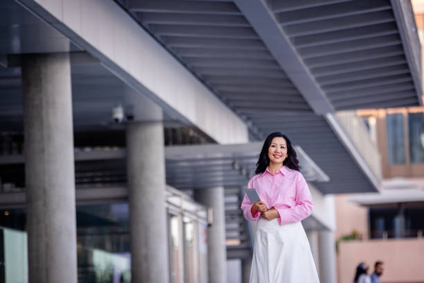 istock Confident woman walking under modern urban architecture 2185807713