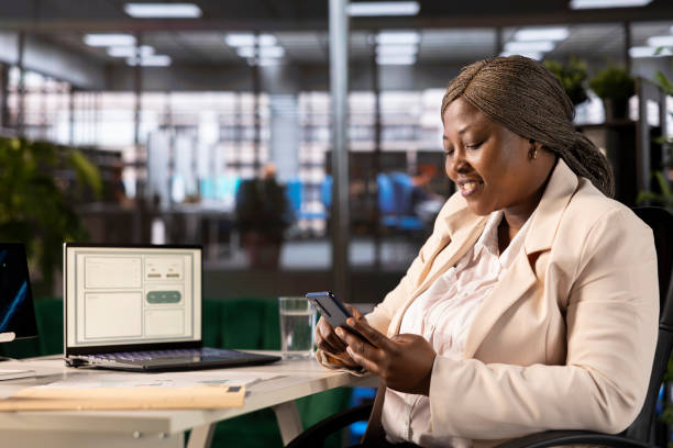 istock Cheerful bookkeeper using smartphone to check business financial figures 2185811048