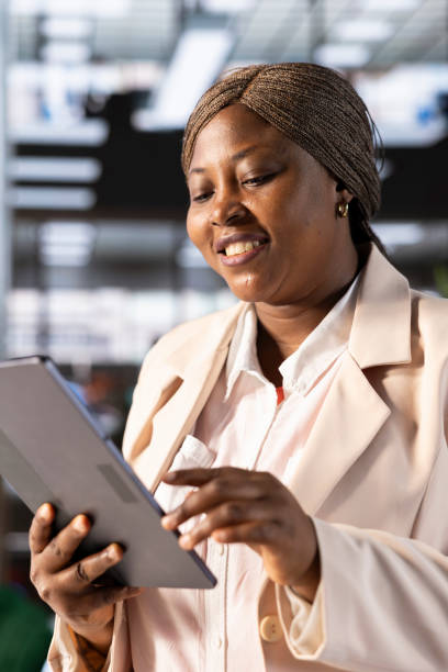 Happy bookkeeper using tablet to check business financial figures and documents