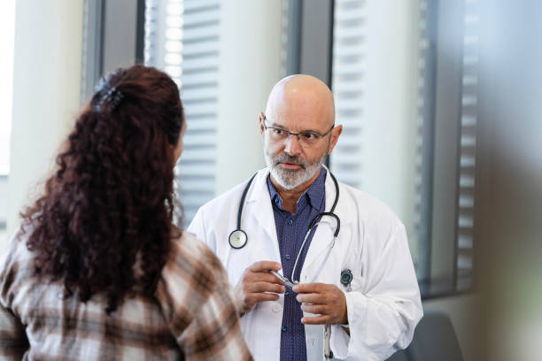 istock Serious doctor talking with patient's mom 2185812103