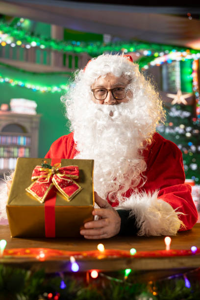 istock Saint Nicholas decorates a festive present box in his North Pole workshop 2185814163