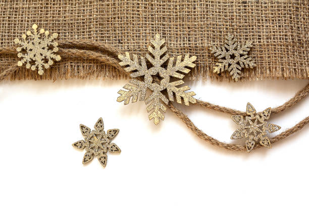 Christmas decorations with snowflakes and burlap on a white background