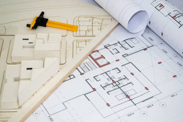 istock architectural and construction plans. Architectural model to scale and measuring instruments 2185822001