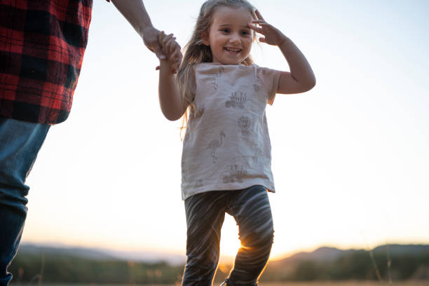 istock Family Day Outdoors. Holding Hands While Hiking at Sunset 2185825095