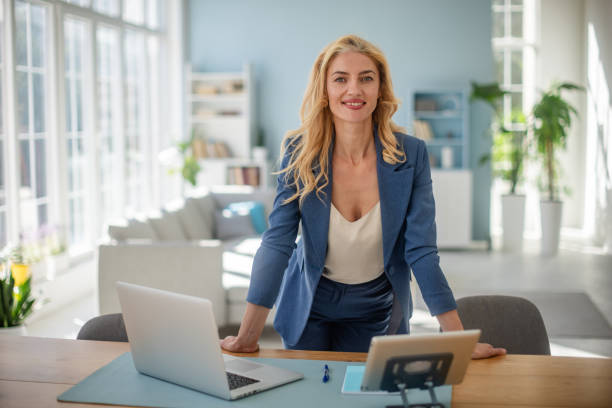 istock Confident female professional at desk with tablet 2185826713
