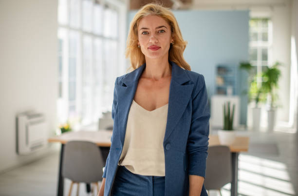 istock Confident woman in a well-lit modern office setting 2185826897