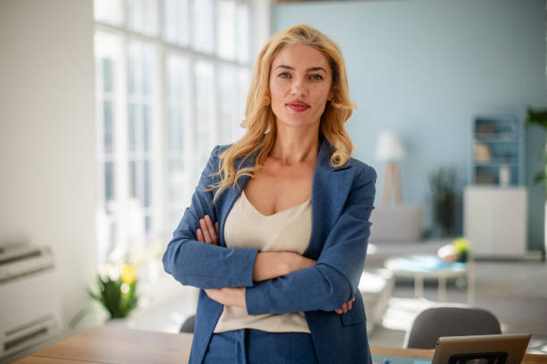 istock Confident woman in blue suit at modern office desk 2185826941