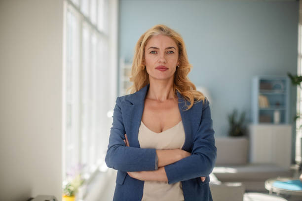 istock Confident woman posing with crossed arms in office 2185827009